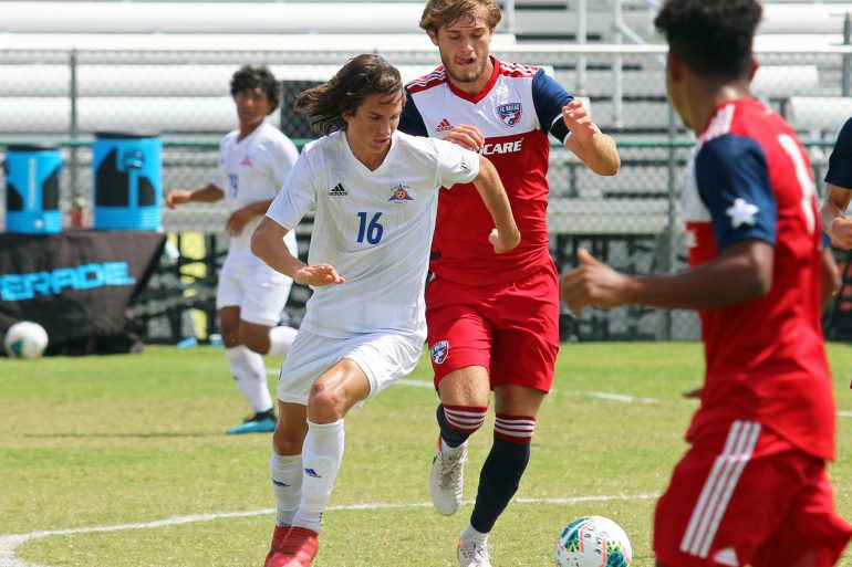 Bailey Sparks (Solar, white) and Tanner Tessmann (red) go head to hear in a 2019 U19 DA game. (Courtesy Solar SC U19s)