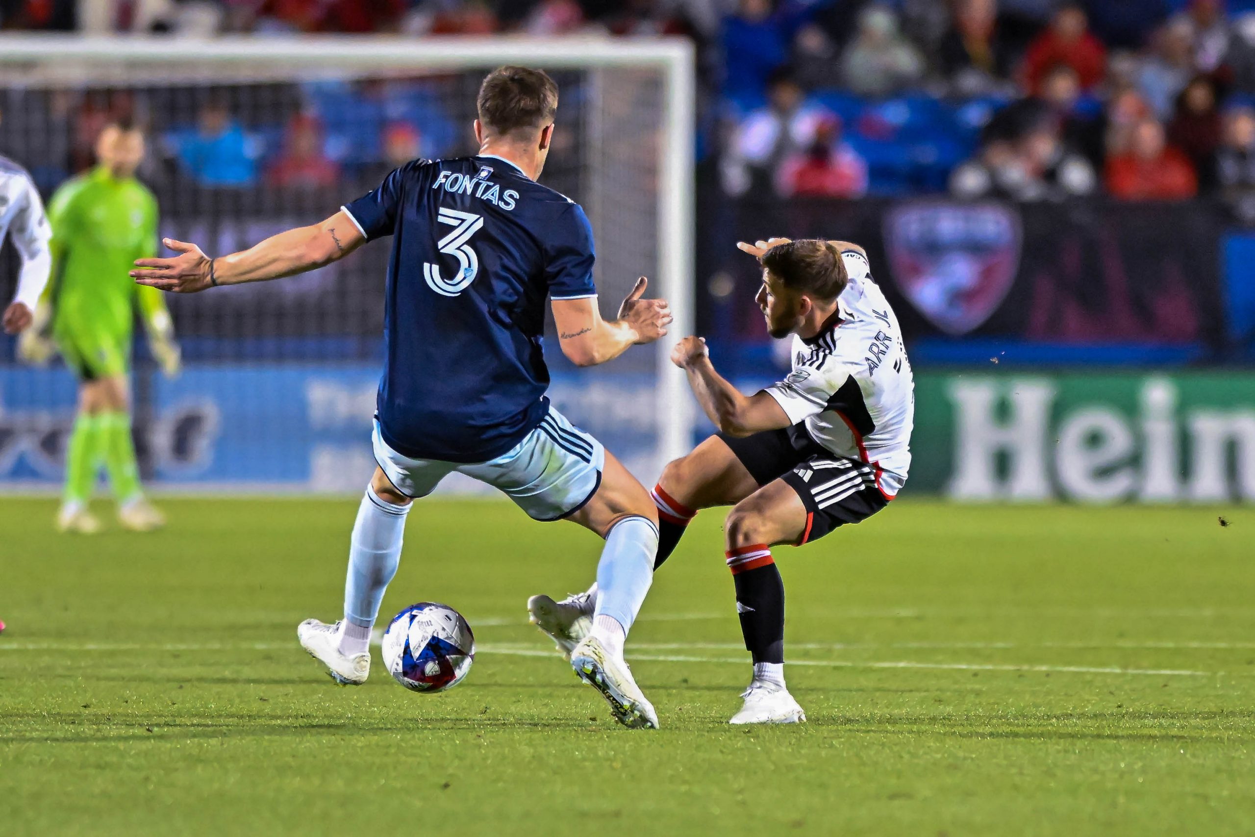 Paul Arriola megs Sporting KC defending Andreu Fontas in the MLS match on Saturday, March 18, 2023, at Toyota Stadium. (Daniel McCullough, 3rd Degree)