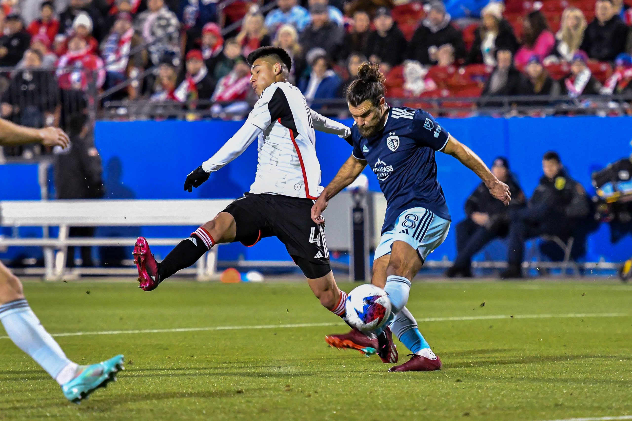 Marco Farfan block Sporting KC defender Graham Zusi’s clearance in the MLS match on Saturday, March 18, 2023, at Toyota Stadium. (Daniel McCullough, 3rd Degree)