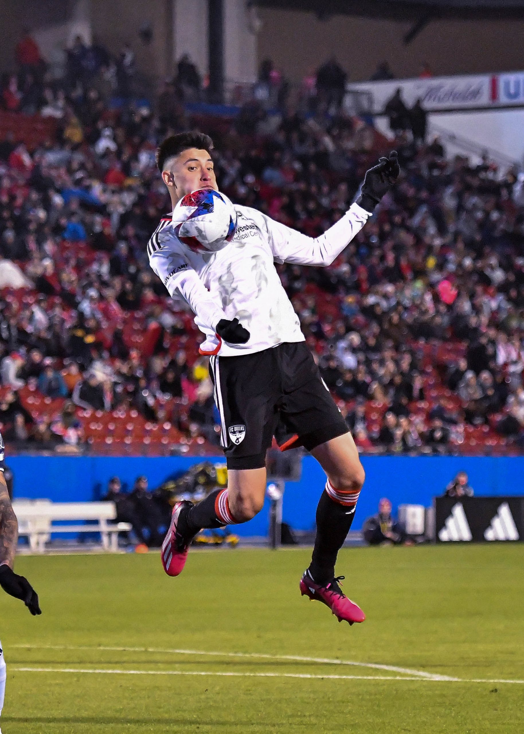 Marco Farfan leaps in the air to chest the ball in the MLS match against Sporting KC on Saturday, March 18, 2023, at Toyota Stadium. (Daniel McCullough, 3rd Degree)