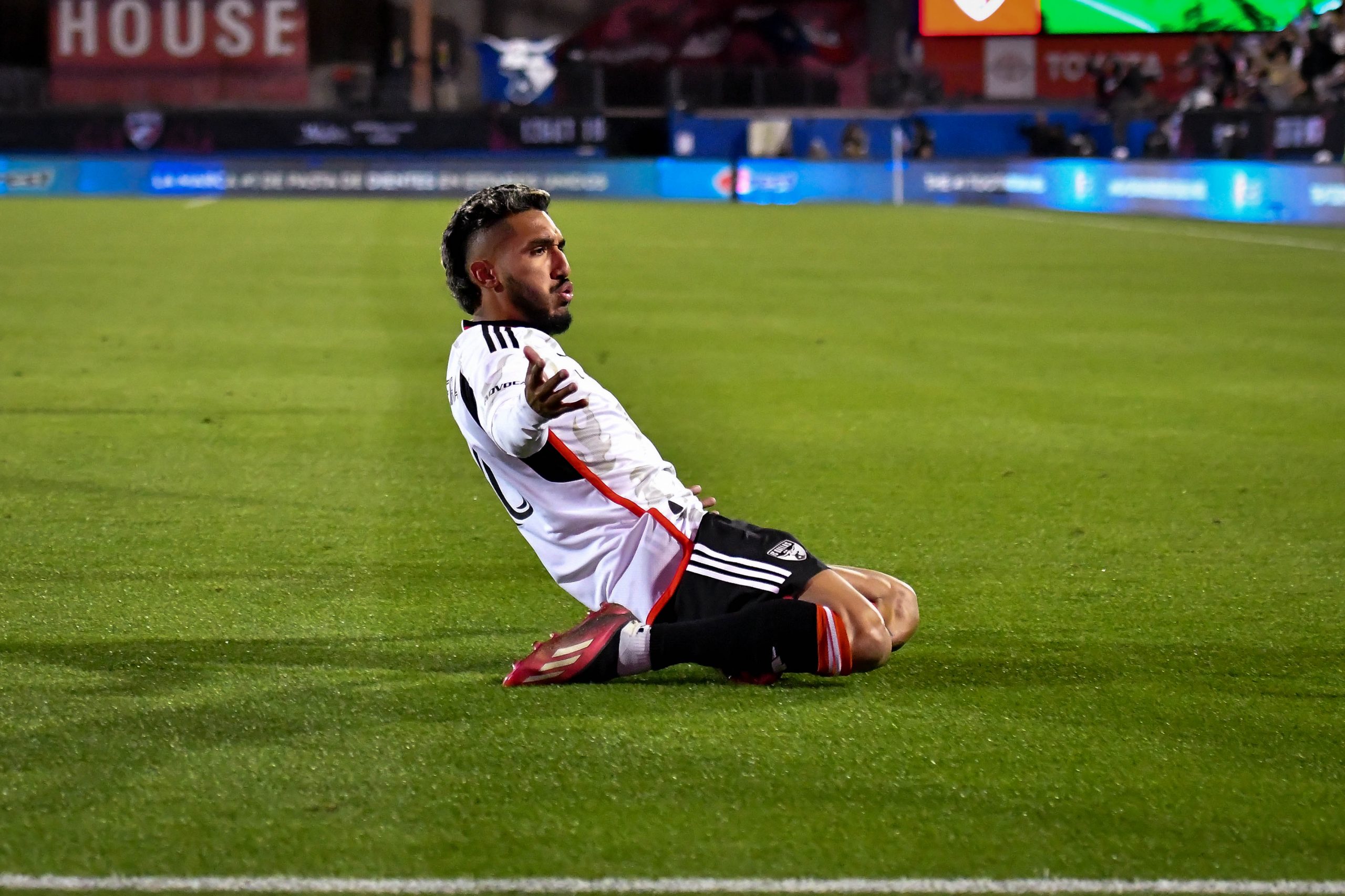 Jesus Ferreira slides toward the crowd after scoring the winning goal in the MLS match against Sporting KC on Saturday, March 18, 2023, at Toyota Stadium. (Daniel McCullough, 3rd Degree)