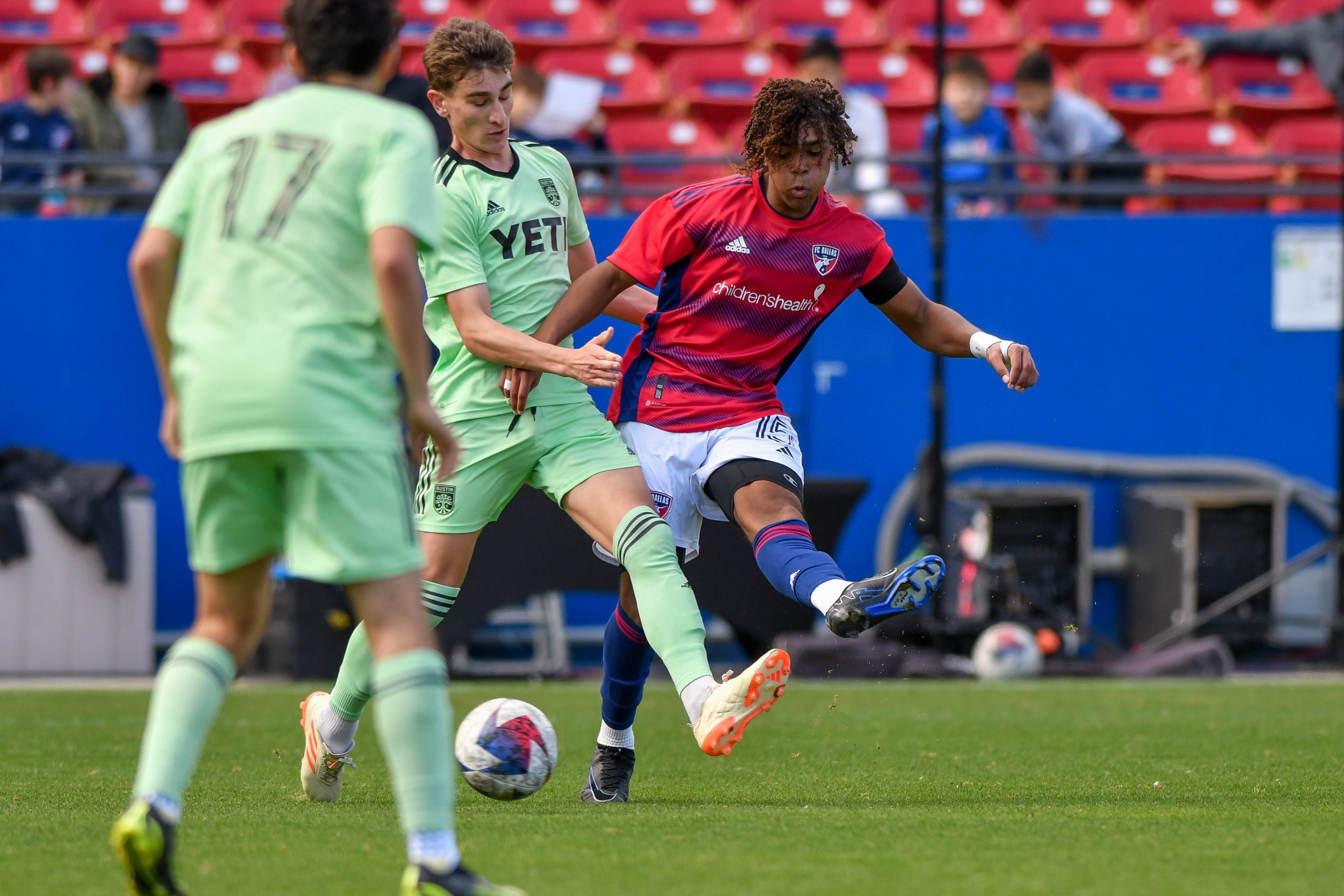FC Dallas U17 defender Ian Charles (15) passes under pressure in the MLS Next match against Austin FC at Toyota Stadium on Sunday, February 4, 2024. (Daniel McCullough / 3rd Degree)