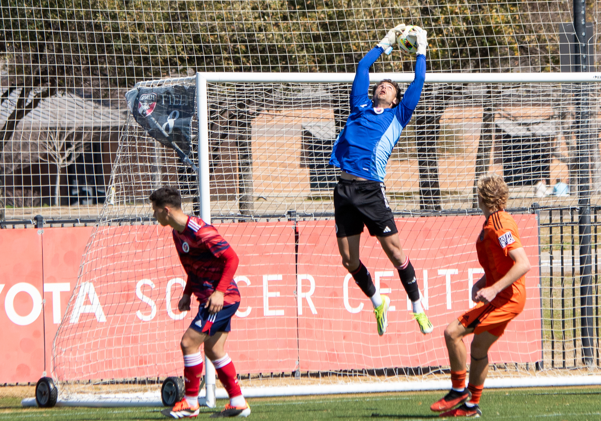A North Texas SC trialist goalkeeper goes up for the ball against Houston Dynamo 2, February 21, 2024. (Brooke Humphrey, 3rd Degree)