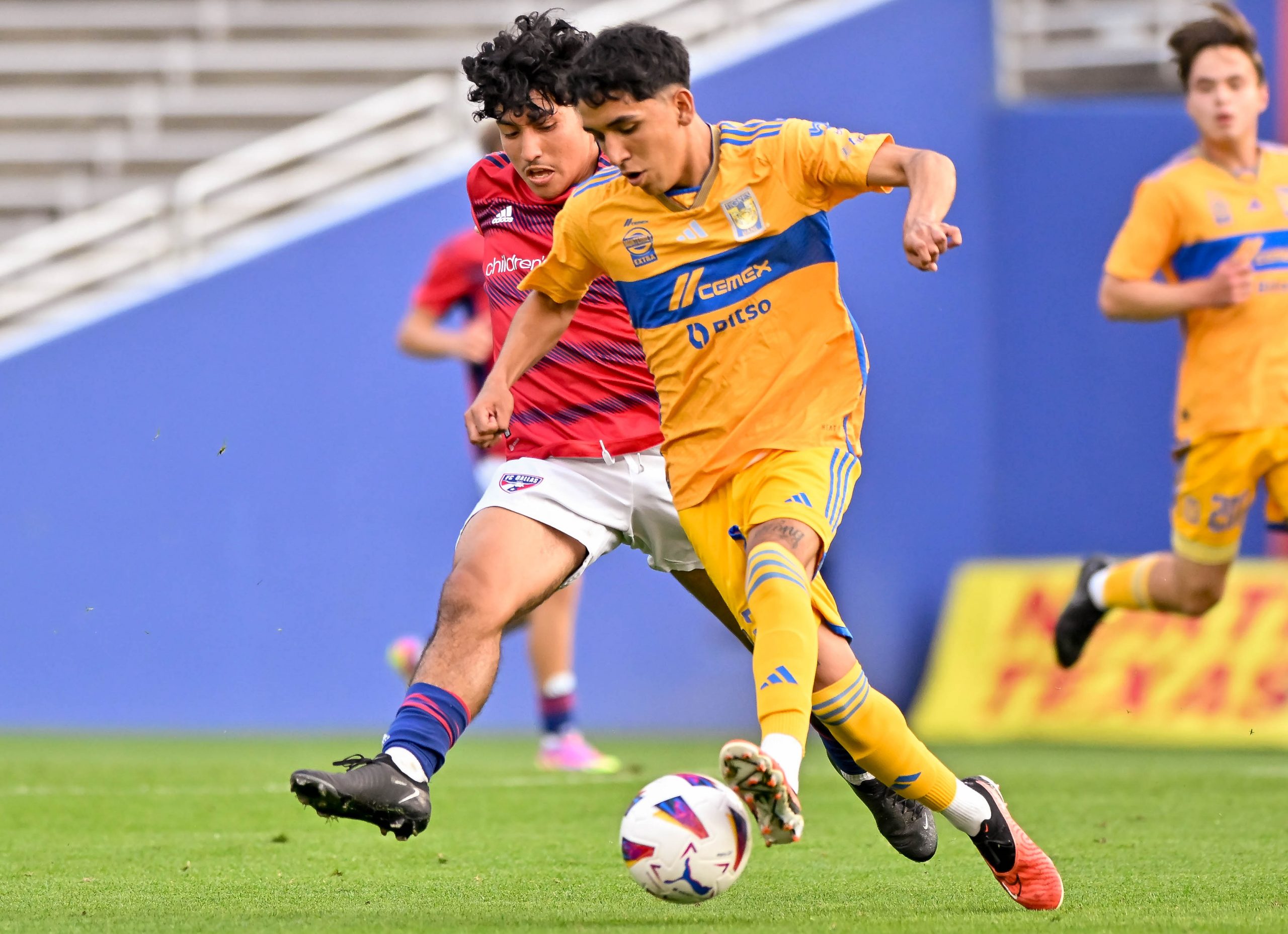 FC Dallas U19 midfielder Rey Marquez dives in on the opponent in the Dallas Cup match against Tigers UANL at the Cotton Bowl on Sunday, March 24, 2024. (Daniel McCullough, 3rd Degree)