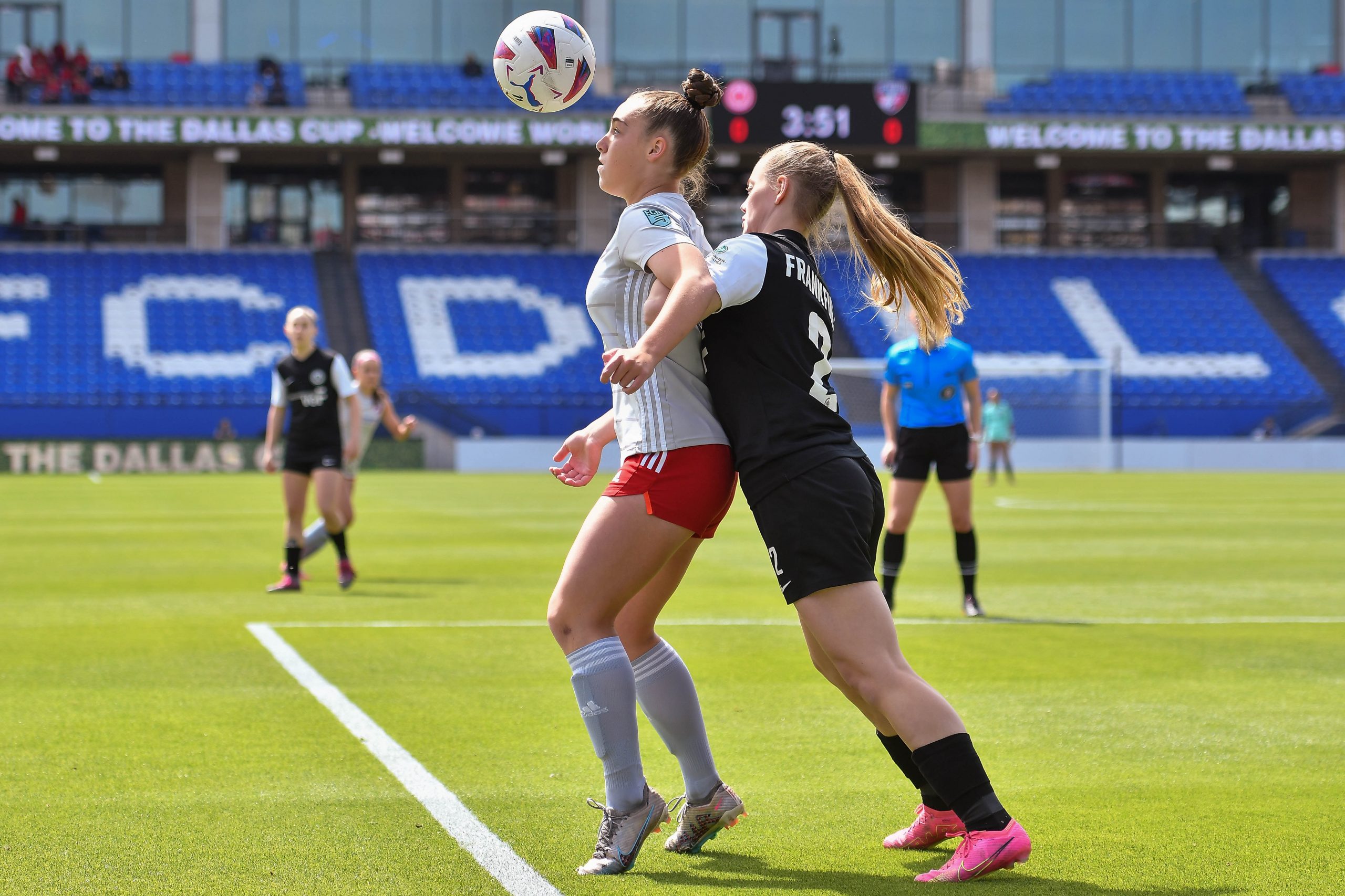 FC Dallas ECNL midfielder Rylee Mclanahan backs up the opposing defender while staring at the ball in the Dallas Cup U17 Final against Eintracht Frankfurt at Toyota Stadium on Saturday, March 29, 2024. (Daniel McCullough, 3rd Degree)