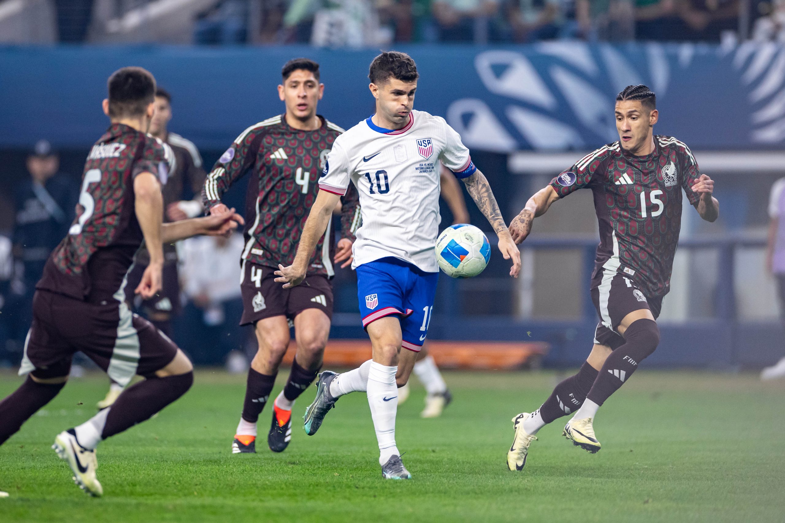 Christian Pulisic fights off a herd of defenders in the USA's 2-0 Nations League Final win over Mexico, March 24, 2024. (Matt Visinsky, 3rd Degree)