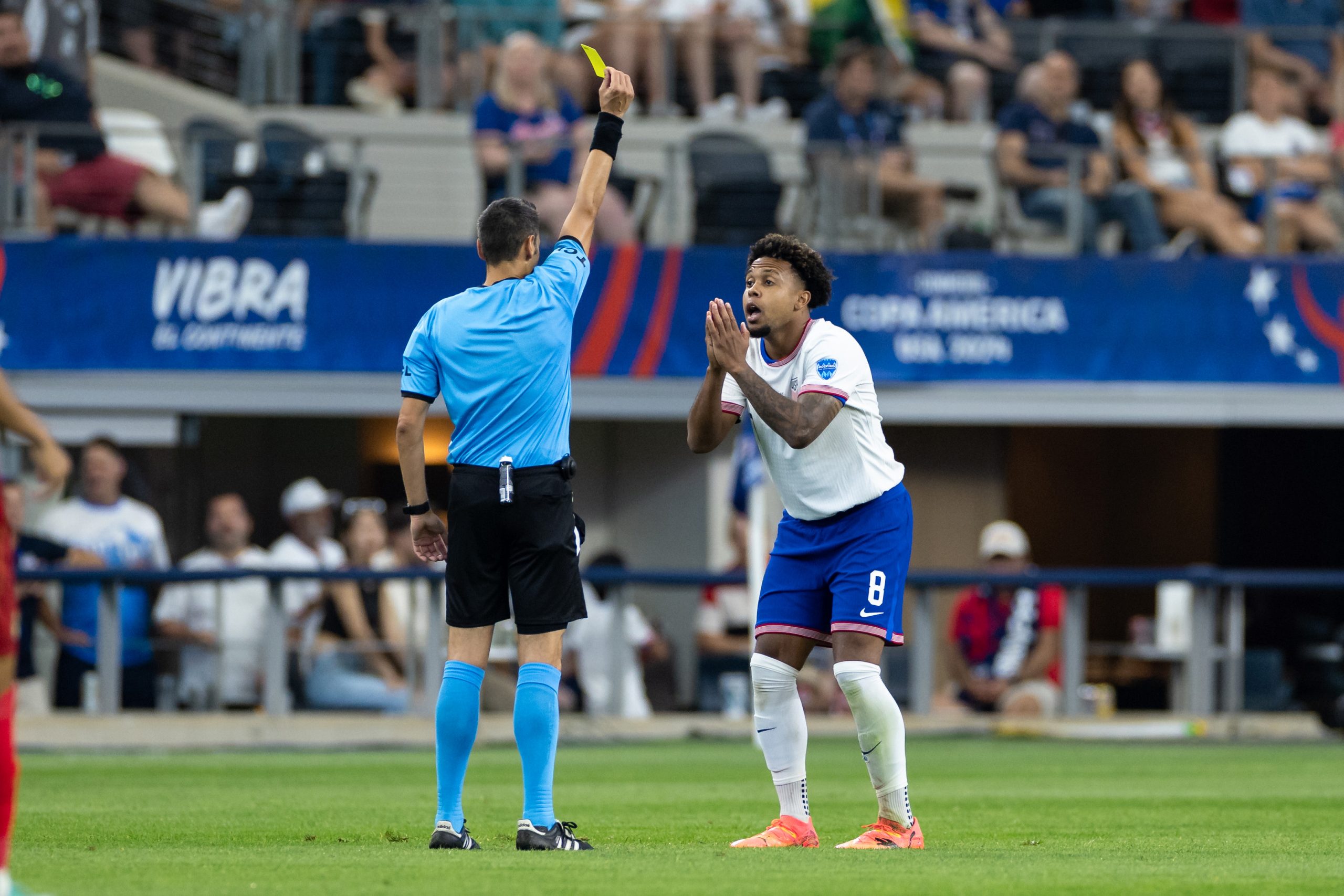 Weston McKennie pleads for mercy but gets a yellow card anyway against Bolivia in Copa American 2024 play at AT&T Stadium, June 23, 2024. (Matt Visinsky, 3rd Degree)