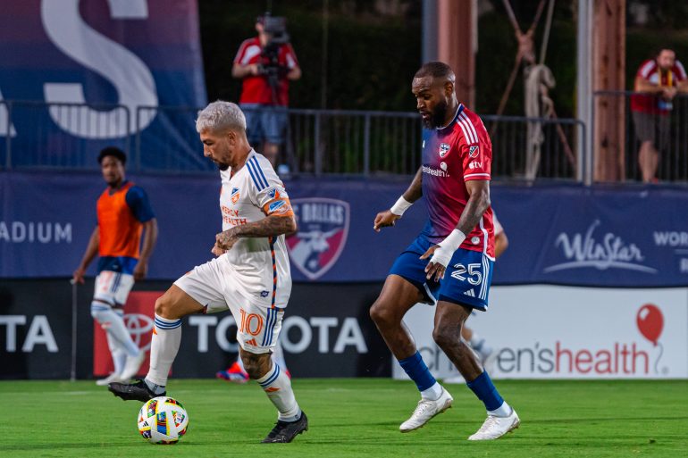Lucho Acosta is marked by Sebastien Ibeagha. (Courtesy FC Dallas)