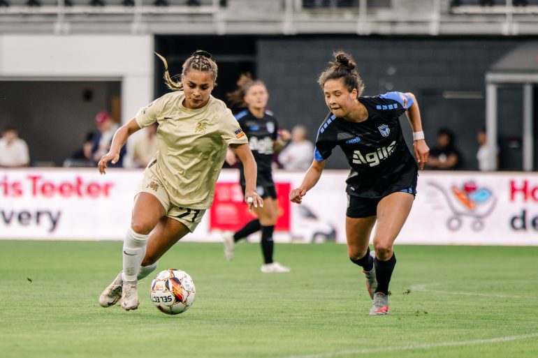 Dallas Trinity FC midfielder Camryn Lancaster takes the ball past DC Power FC's Katie Duong (Dallas Trinity FC)