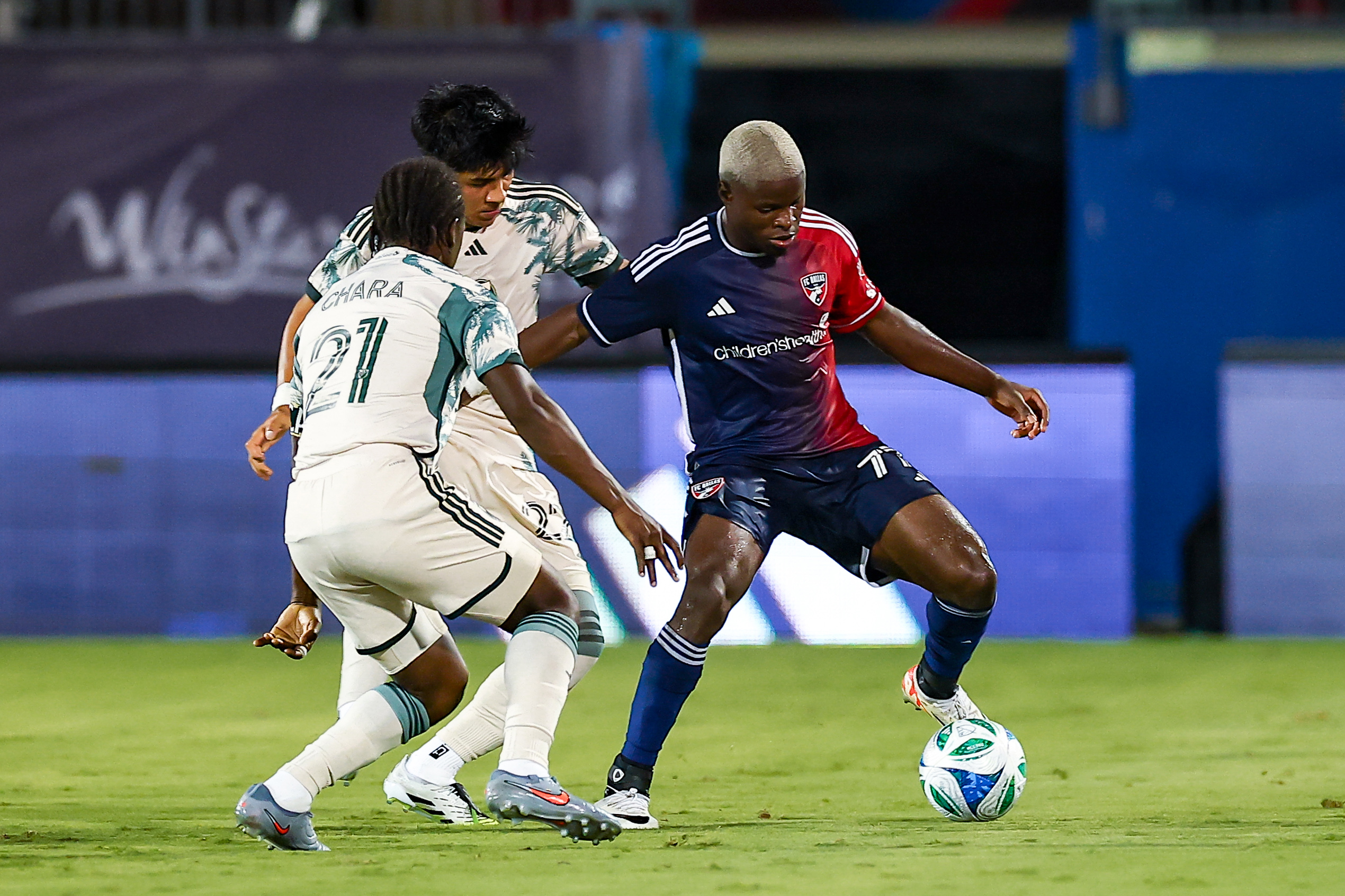 Bernie Kamungo holds off two defenders against Portland Timbers, August 9, 2025. (Matt Visinsky, 3rd Degree)