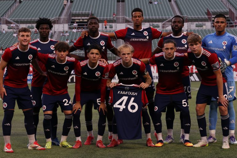 The NTSC XI vs LAFC 2 holds up the jersey of the injured Isaiah Kaakoush who tore an ACL last week, August 24, 2025. (Courtesy North Texas SC)