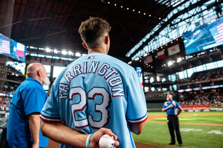 Logan Farrington prepares to throw out the 1st pitch at a Rangers game. (Courtesy FC Dallas)
