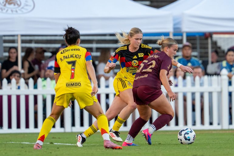 Caroline Swann holds off two Club American defenders in the State Fair Classico, August 18, 2024. (Courtesy Dallas Trinity FC)