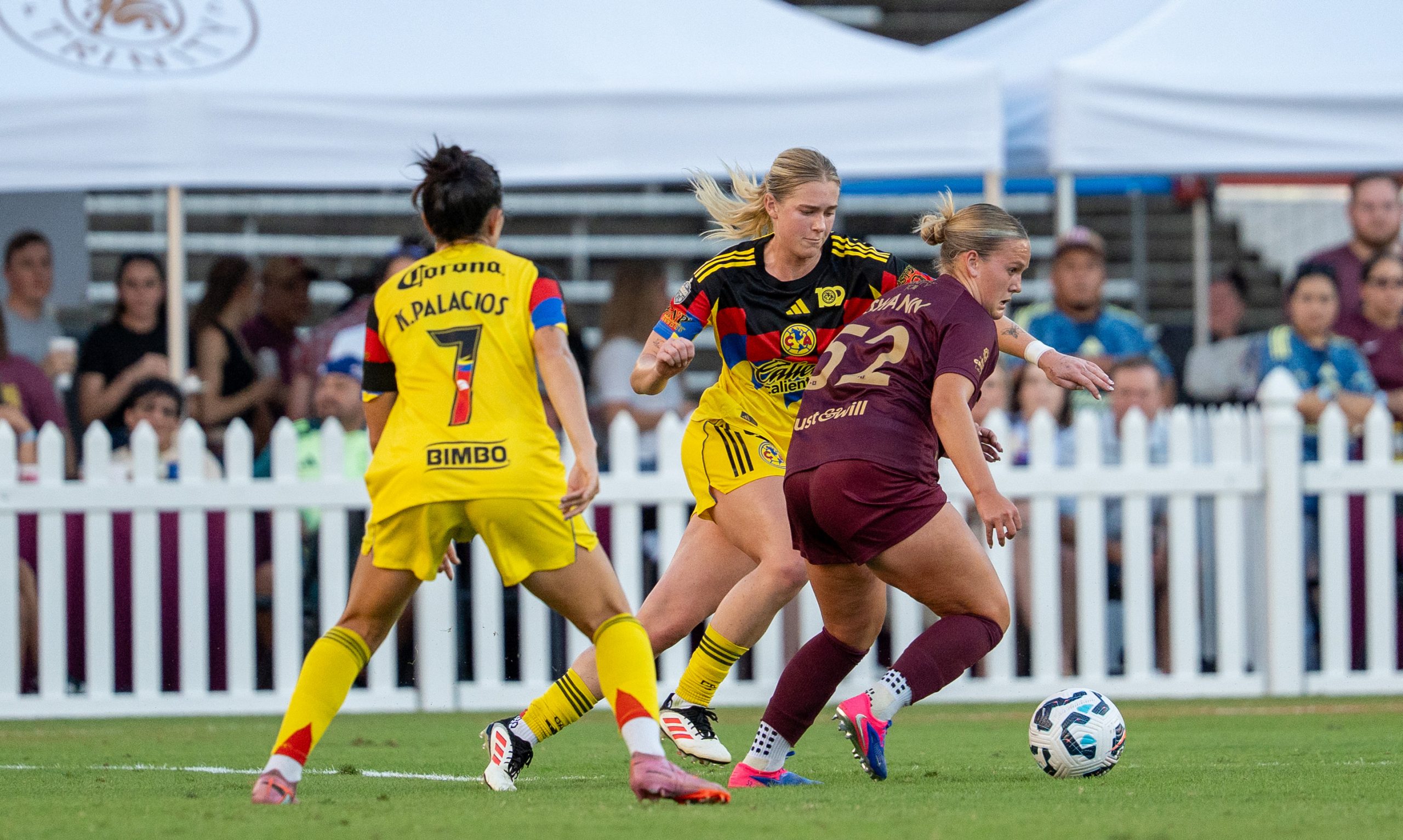 Caroline Swann holds off two Club American defenders in the State Fair Classico, August 18, 2024. (Courtesy Dallas Trinity FC)