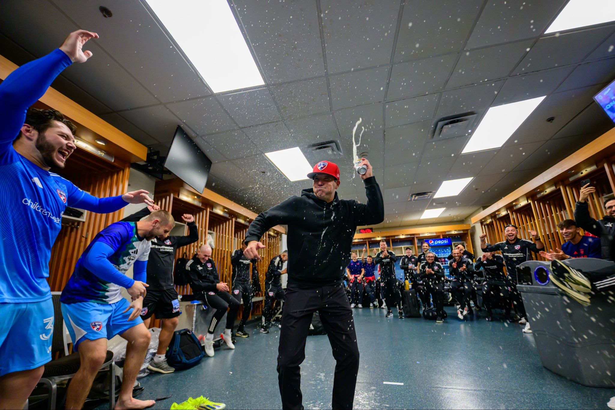 Eric Quill drinks a celebratory beer after FC Dallas made the 2025 MLS Cup Playoffs (FC Dallas Communications)