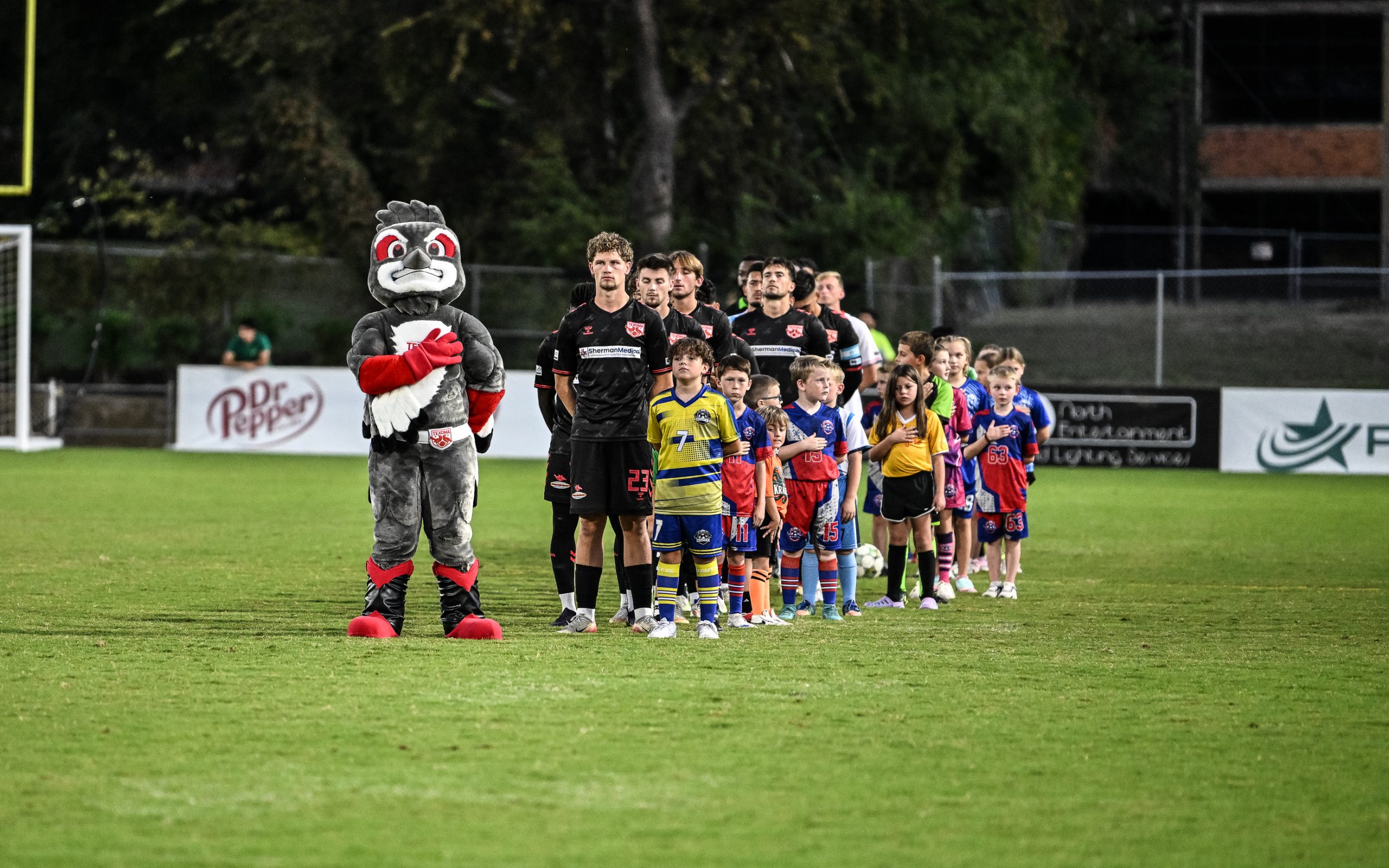 Texoma FC and the Richmond Kickers stand for the National Anthem, October 11, 2025. (Mike Brooks, 3rd Degree)
