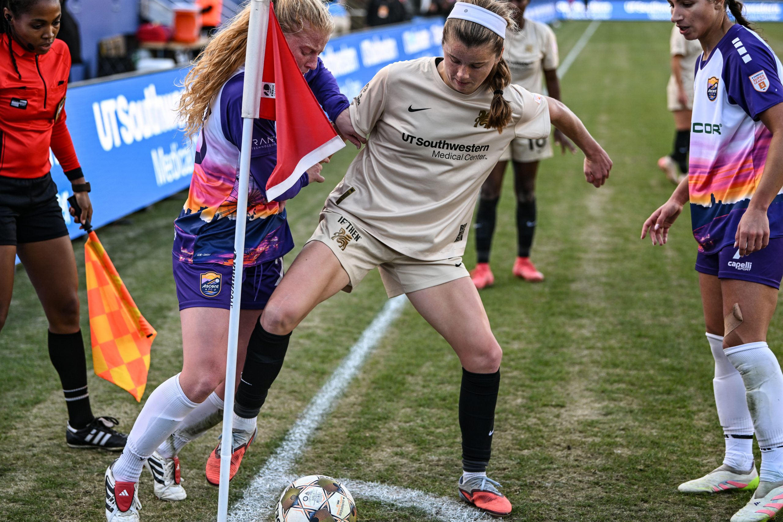 Carolina Kelly holds off two defenders near the corner flag in the 1-0 Dallas Trinity win over Carolina Ascent, December 13, 2025. (Mike Brooks, 3rd Degree)