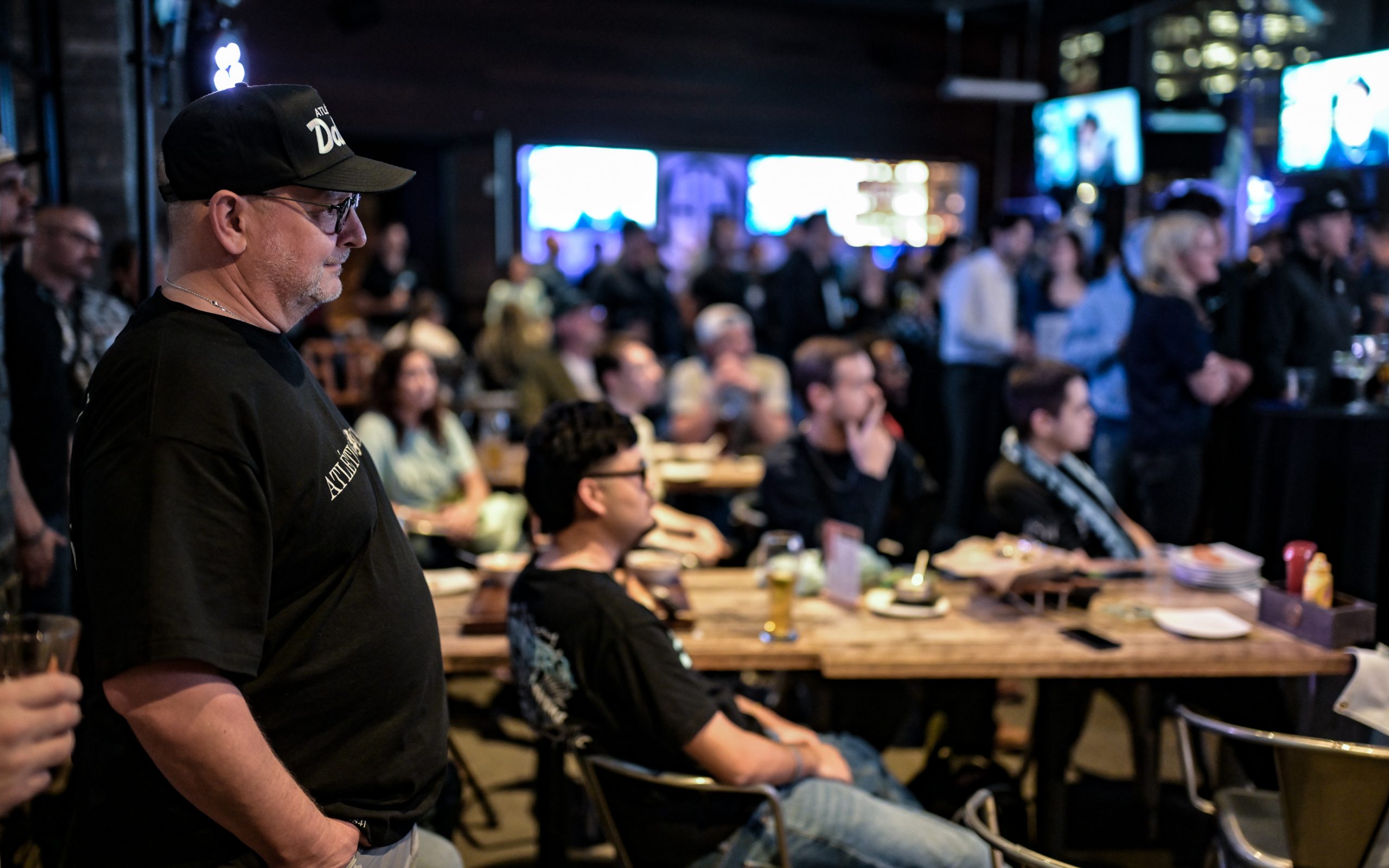 Sam Morton, Atlético Dallas Co-Founder, (left, hat) watches from the crowd at the Atlético Dallas introduction event of new head coach Peter Luccin, February 12, 2026. (Mike Brooks, 3rd Degree)