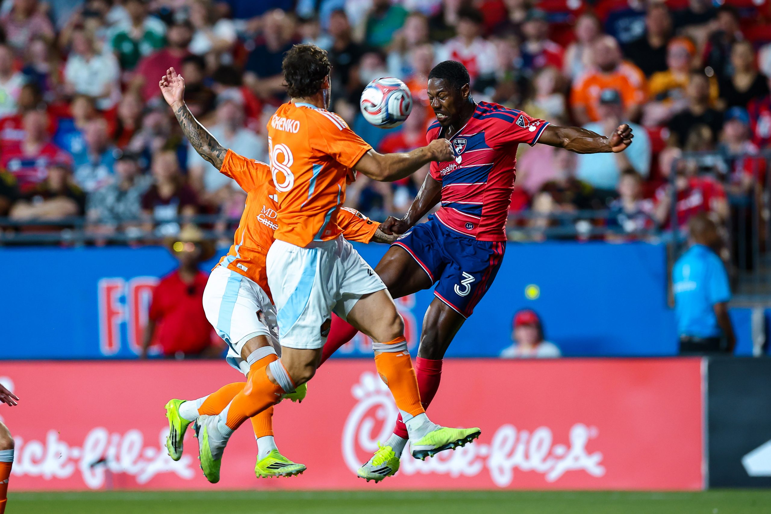 Osaze Urhghide goes up for a header against 2 Dynamo defenders in the match against Houston, March 21, 2026. (Matt Visinsky, 3rd Degree)