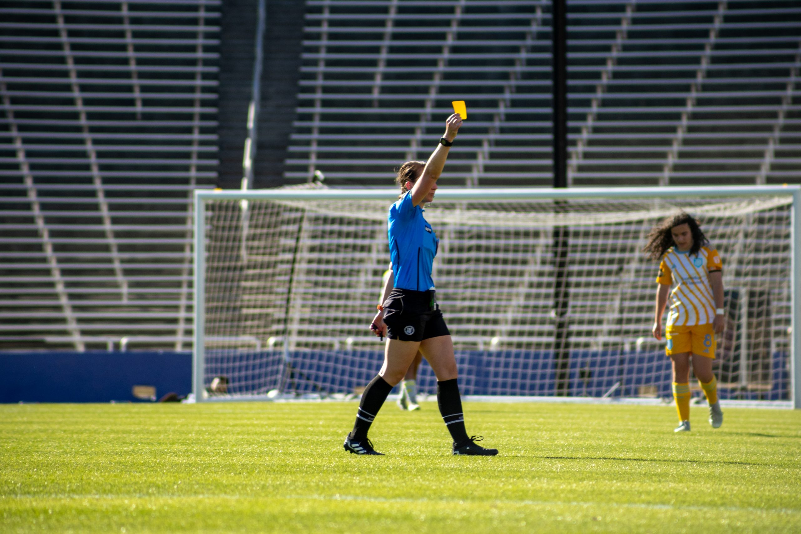 The referee hands out a yellow card in the Sporting JAX versus Dallas Trinity, March 22, 2026. (Beth Spicer, 3rd Degree)
