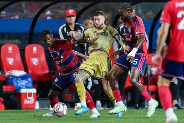 FC Dallas' Patrickson Delgado and Sebastien Ibeagha fight for the ball while Coach Eric Quill looks one, April 11, 2026. (Matt Visinsky, 3rd Degree)