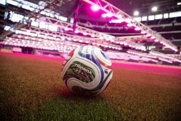 An adidas Trionda ball on the grass surface at Dallas Stadium (North Texas FWC Organizing Committee/Tony Fay PR)