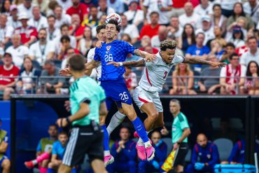 Peta Musa (26) jumps for a header over two defenders, Croatia v England in the World Cup, June 17, 2026 at "Dallas Stadium." (Matt Visinsky, 3rd Degree)