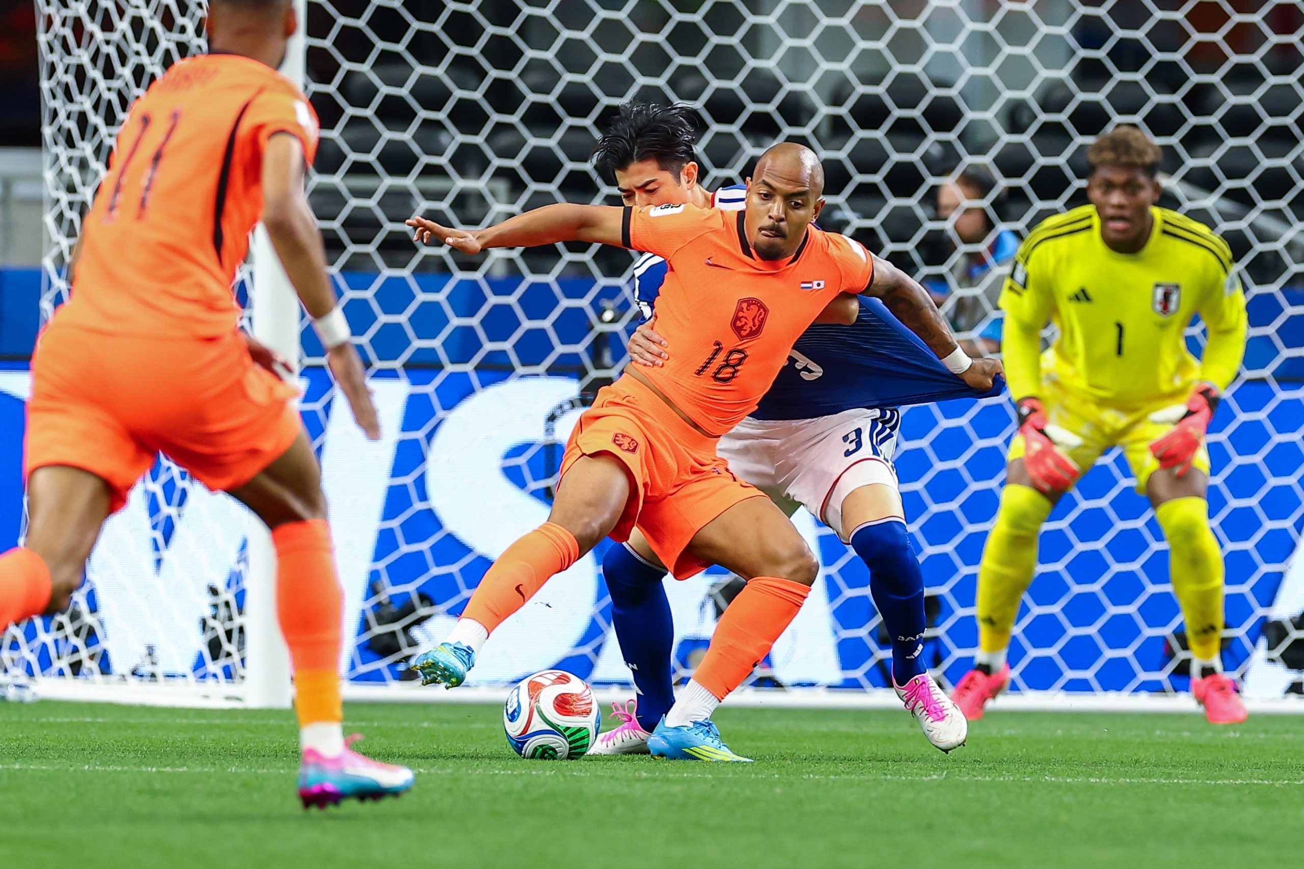 Donyell Malen (18) fends off Shogo Taniguchi(3). Japan vs Netherlands, at "Dallas Stadium," 2026 World Cup, June 14, 2026. (Matt Visinsky, 3rd Degree)