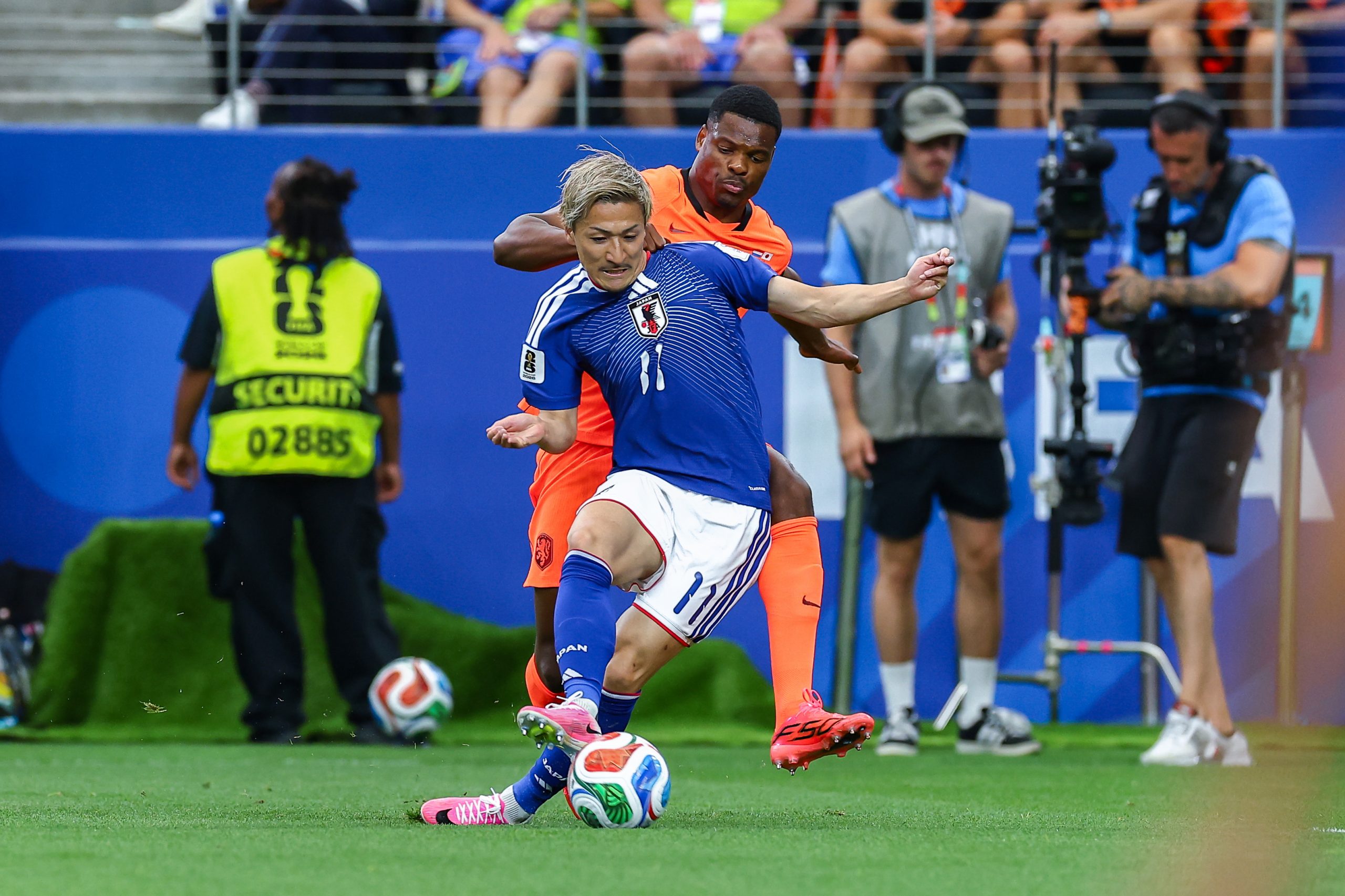 Daizen Maeda (11) is grabbed from behind. Japan vs Netherlands, at "Dallas Stadium," 2026 World Cup, June 14, 2026. (Matt Visinsky, 3rd Degree)