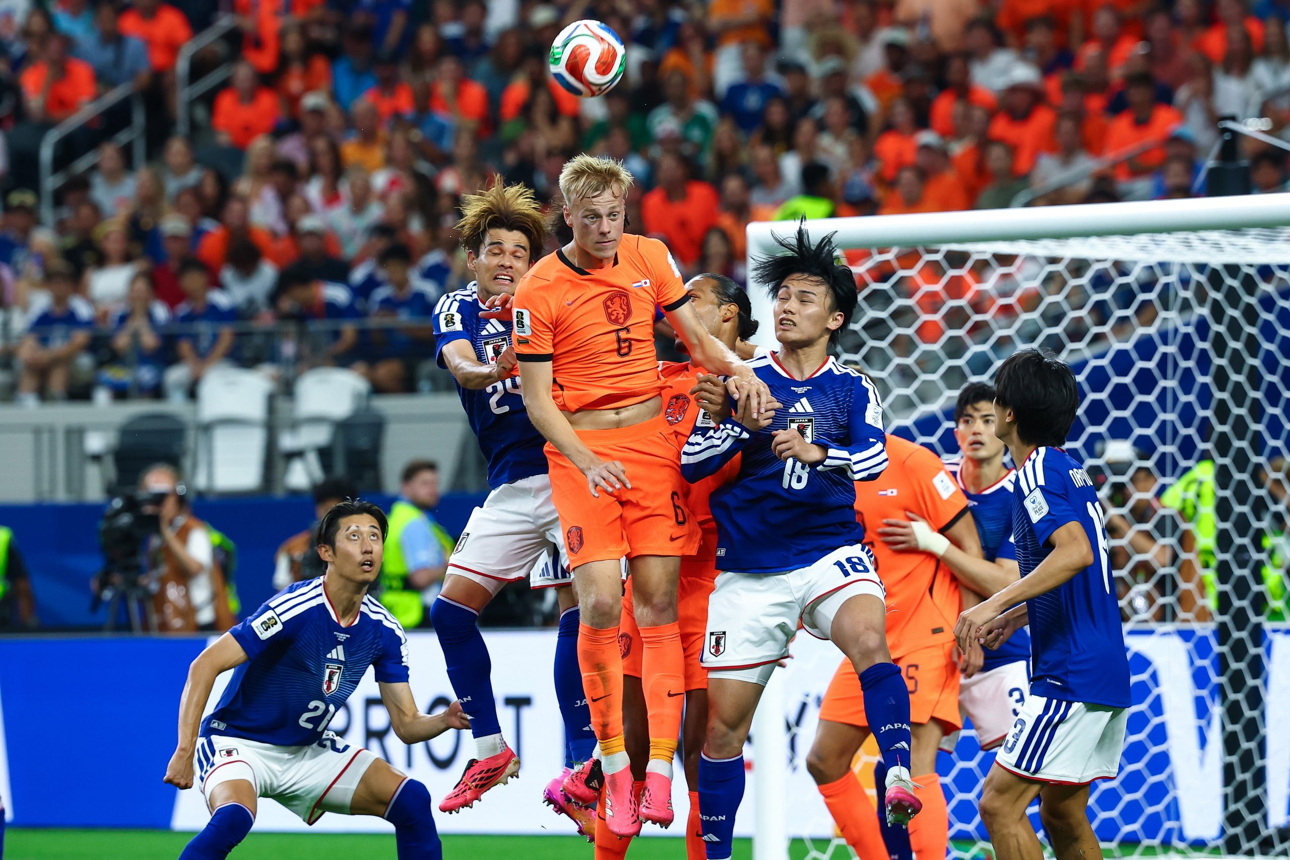 Jan Paul van Hecke (6) wins a header in a crowd. Japan vs Netherlands, at "Dallas Stadium," 2026 World Cup, June 14, 2026. (Matt Visinsky, 3rd Degree)