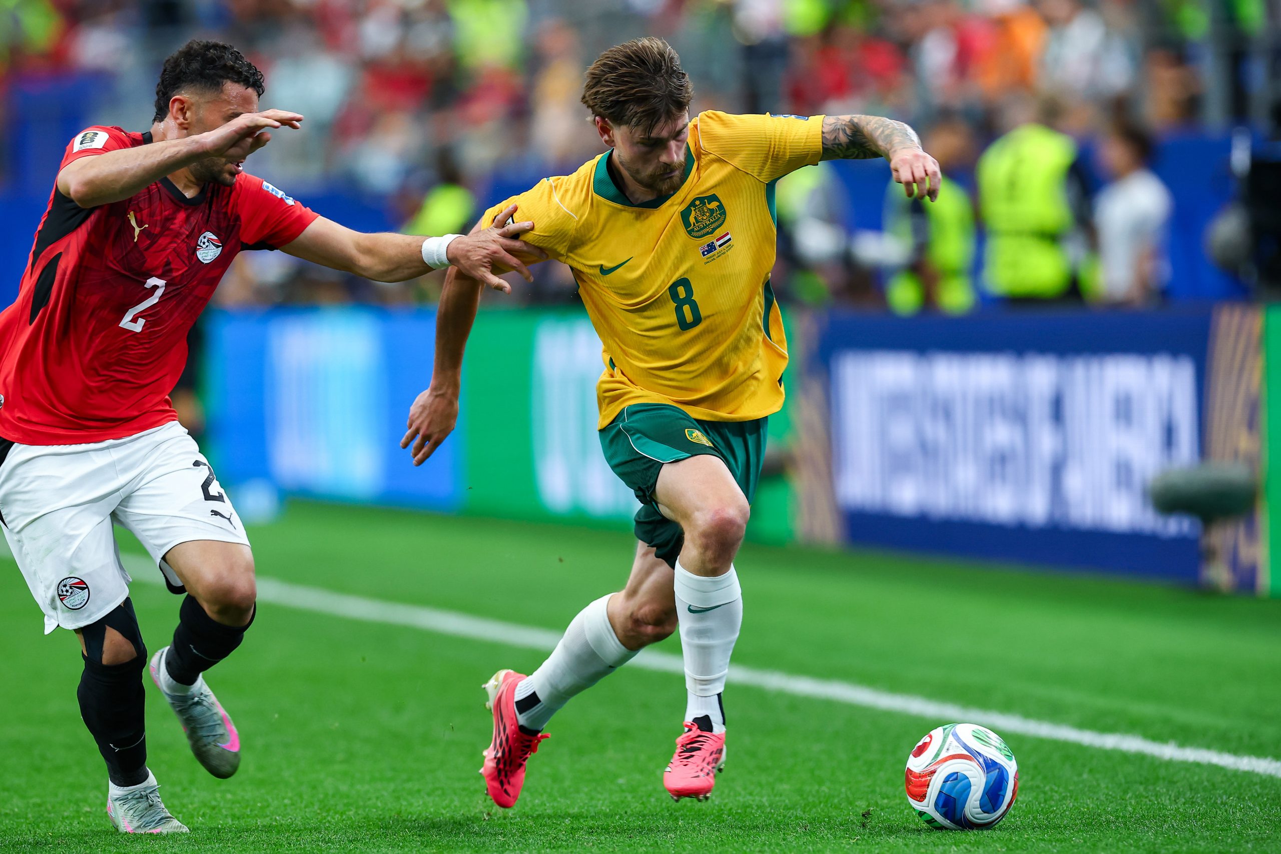 Connor Metcalfe (8) drives past Yasser Ibrahim (2). Australia vs Egypt, 2026 World Cup, Dallas Stadium, June 27, 2026. (Matt Visinsky, 3rd Degree)