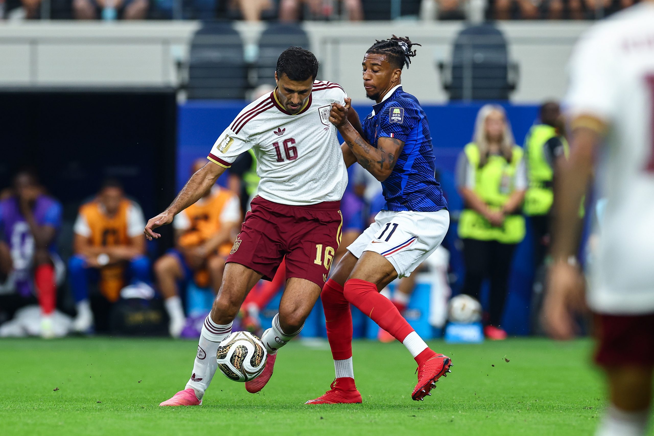 Rodri (16) escapes from Michael Olise (11). France vs Spain, 2026 World Cup, Dallas Stadium, July 14, 2026. (Matt Visinsky, 3rd Degree)