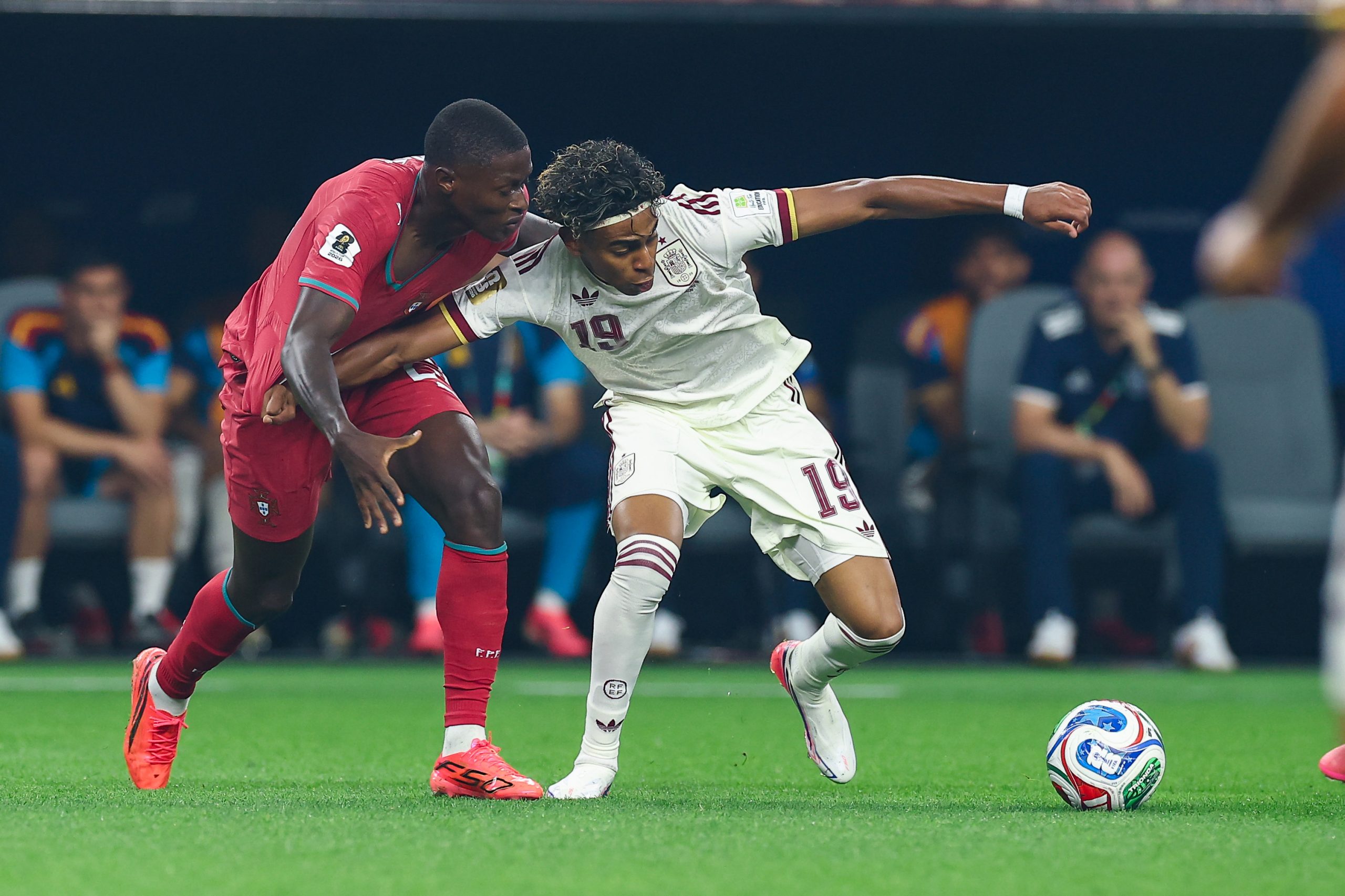 Lamine Yamal (19) holds off Nuno Mendes (25). Portugal vs Spain, 2026 World Cup, Dallas Stadium, June 27, 2026. (Matt Visinsky, 3rd Degree)