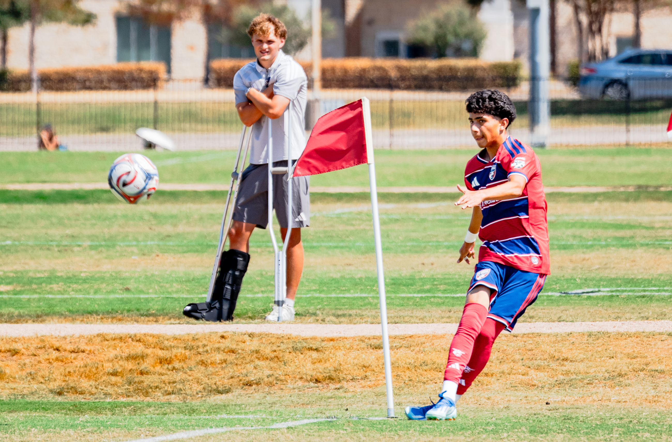 Pedro Dias (8) of the FC Dallas U18s takes a corner vs Austin FC while the injured Christian Wygant watches, September 18, 2025. (Ronit Chhabra, 3rd Degree)