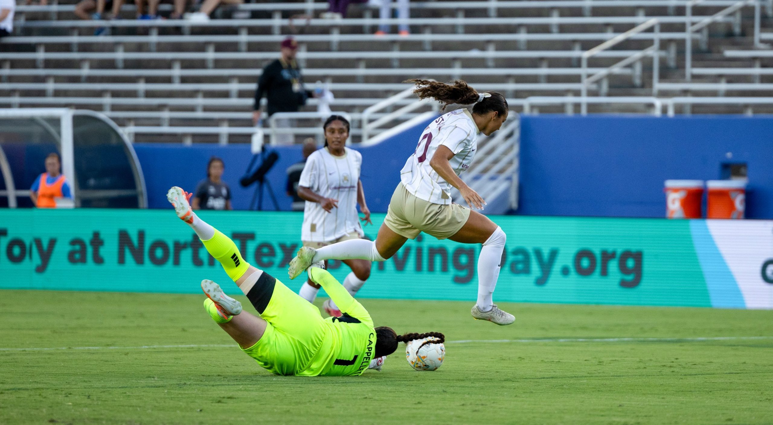 Seven Castain (30) tries to leap over the diving keeper Katherine Cappelletti (1) as Dallas Trinity takes on DC Power, September 13, 2026. (Beth Spicer, 3rd Degree)
