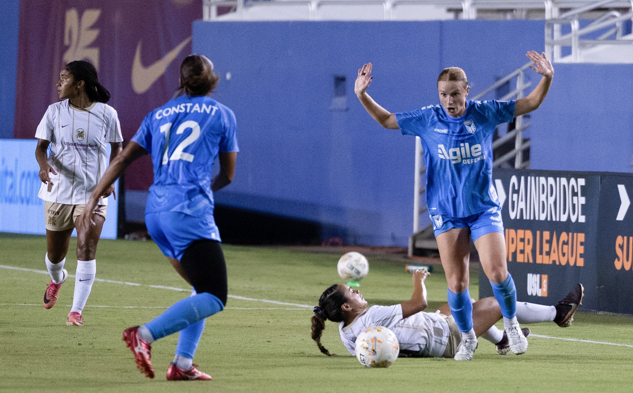 Camryn Lancaster (21) is knocked down by Susanna Fitch (3) as Dallas Trinity takes on DC Power, September 13, 2026. (Beth Spicer, 3rd Degree)