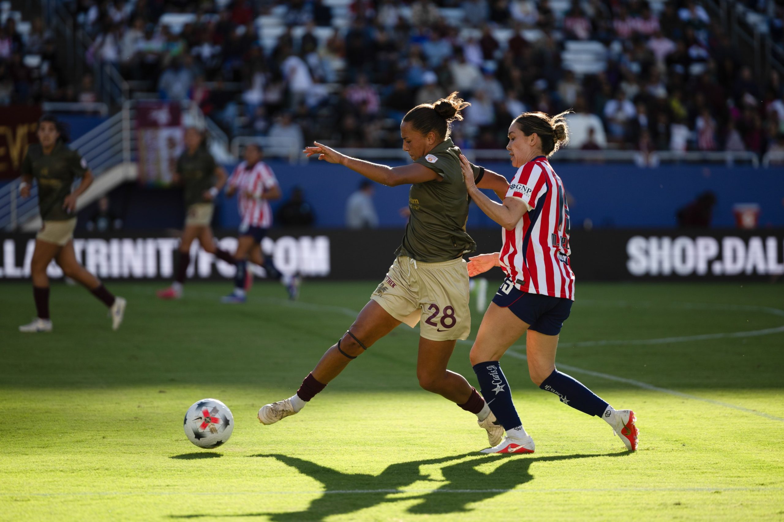 Carissa Boeckmann (28) shields the ball from a Chivas defender. Dallas Trinity vs Chivas Femenil, 2026 State Fair Clásico, October 17. 2026. (Beth Spicer, 3rd Degree)